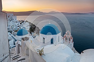 Sunset at the Island Of Santorini Greece, beautiful whitewashed village Oia with church and windmill during sunset