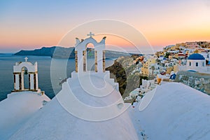 Sunset at the Island Of Santorini Greece, beautiful whitewashed village Oia with church and windmill during sunset