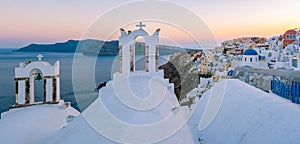 Sunset at the Island Of Santorini Greece, beautiful whitewashed village Oia with church and windmill during sunset