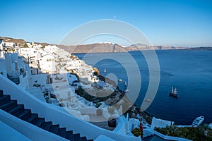 Sunset at the Island Of Santorini Greece, beautiful whitewashed village Oia with church and windmill during sunset