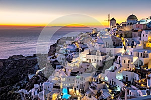 Sunset at the Island Of Santorini Greece, beautiful whitewashed village Oia with church and windmill during sunset