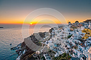 Sunset at the Island Of Santorini Greece, beautiful whitewashed village Oia with church and windmill during sunset