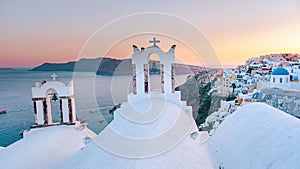 Sunset at the Island Of Santorini Greece, beautiful whitewashed village Oia with church and windmill during sunset