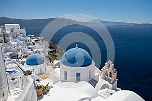 Sunset at the Island Of Santorini Greece, beautiful whitewashed village Oia with church and windmill during sunset