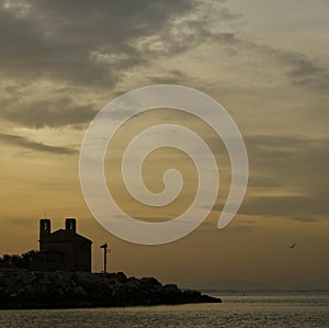 The sunset on the island of Tabarca, on a winter sunset photo