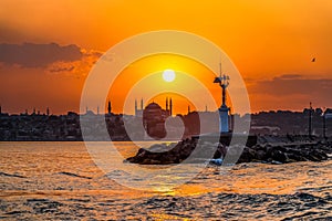 Sunset in istanbul, silhouette of the historical peninsula. Sunset over Hagia Sophia and Historical Peninsula. Lighthouse