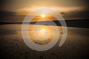 Sunset and its reflecrion on a lake