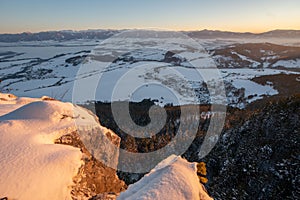 Sunset from Janosikov stol rock over Liptovska Anna village in Chocske vrchy mountains during winter