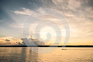 A sunset at the Javari River with boar passing by