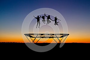 Sunset kids on trampoline photo