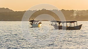 A sunset on Koh Rong island with two boats