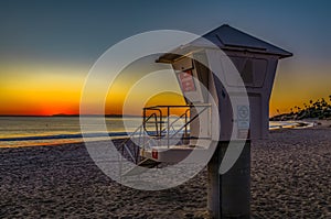 Sunset in Laguna Beach, famous tourist destination in California, USA with a lifeguard station in the foreground