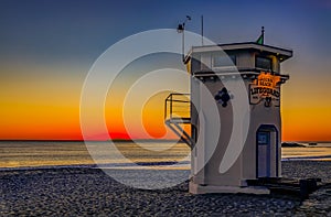 Sunset in Laguna Beach, famous tourist destination in California, USA with a lifeguard station in the foreground