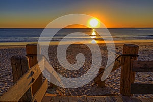 Sunset in Laguna Beach, famous tourist destination in California, USA with wooden stairs in the foreground