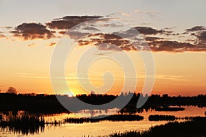 Sunset on the lake in the forest. A relaxing place to relax in nature.