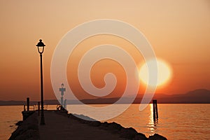 Sunset at lake of Garda with man silouette