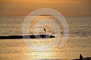 Sunset turns sky and water to gold. Lake Michigan, one of the Great Lakes in the Midwest, USA.