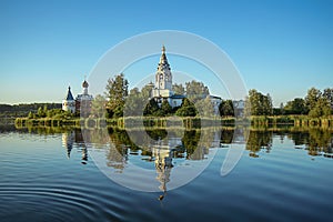 Sunset on the lake. Monastery with reflection in blue water