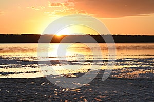 Sunset on the lake. The sun setting over the horizon