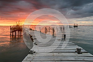 Sunset landscape of artisanal fishing boats in the old wooden pier