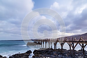 Sunset landscape with bridge on the beach,whit cloudy sky in lanzarote canary islands-.CR2