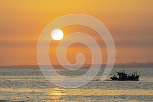 Sunset landscape when fishing boats out to sea