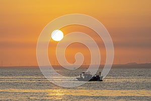 Sunset landscape when fishing boats out to sea