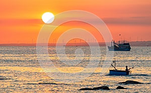 Sunset landscape when fishing boats out to sea