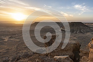 Sunset landscape over the salt lake of Bahariya oasis as seen from the top of Jebel Dist