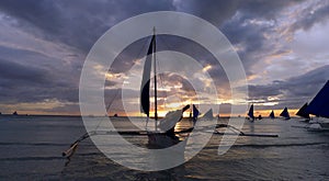 Sunset landscape. Sailboat on coast of Boracay island. Philippines