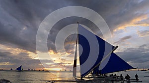 Sunset landscape. Sailboat on coast of Boracay island. Philippines