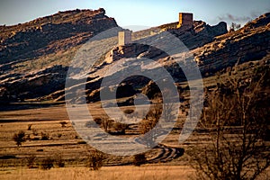 Sunset landscape with some mountains and a castle o