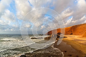 Sunset in Legzira beach with red arch, Atlantic ocean, Sidi Ifni