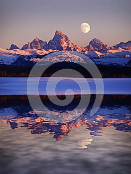 Sunset Light Alpen Glow on Tetons Teton Mountains wtih Moon Rising reflect reflection water pond lake