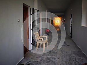 Sunset light entering in apartment varanda. Siting chair outside on the house for relaxation photo