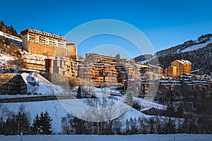 Sunset light illuminating Soldeu town ski slopes and snow capped mountains, Andorra