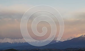 Sunset of light and mist on the snow-capped peaks of the Apennines