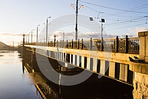 Sunset light over bridge and river in Riga