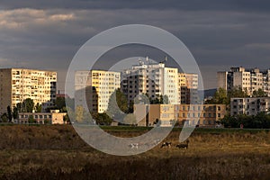 Sunset light paints large communist-style apartment buildings