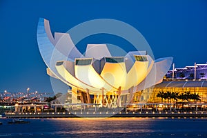 Sunset lights over the Marina Bay Sands Amphitheatre and ArtScience Museum in Singapore