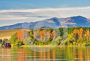 Sunset on Liptovska Mara dam with Chocske vrchy mountains on horizont