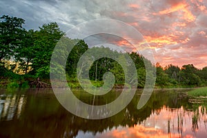 Sunset long the banks of the Amazon river. The tributaries of the Amazon traverse the countries of Guyana, Ecuador, Peru, Brazil,