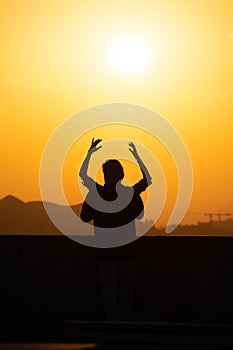 Sunset and lovers. Woman and man against the backdrop of sunset. Orange sky a