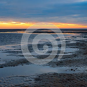 Sunset in the Lower Saxony Wadden Sea off Cuxhaven Sahlenburg at low tide, Germany