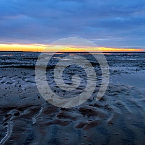 Sunset in the Lower Saxony Wadden Sea off Cuxhaven Sahlenburg at low tide, Germany