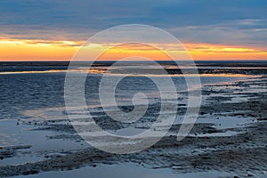 Sunset in the Lower Saxony Wadden Sea off Cuxhaven Sahlenburg at low tide, Germany