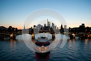 Sunset at the Main river in Frankfurt  Germany with skyline  bridge and party boat