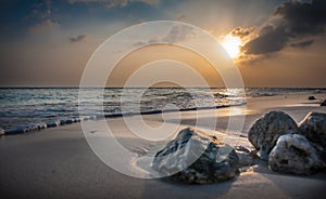 Sunset in the Maldives. Beautiful colorful sunset over the ocean in the Maldives seen from the beach.Amazing sunset and beach