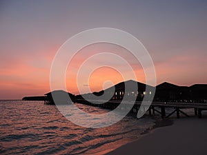 Sunset on Maldives, Indian Ocean, luxury resort Island. Beautiful sunset landscape and colorful sky.