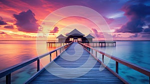 Sunset on Maldives island, luxury water villas resort and wooden pier. Beautiful sky and clouds and beach background for summer